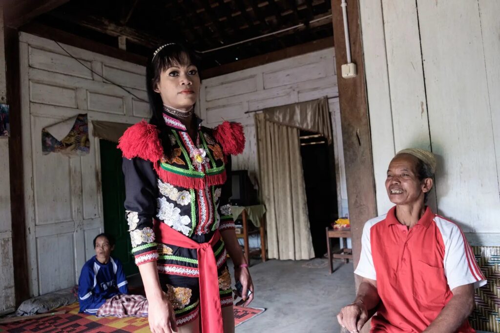 Andi with his parents at their home in Tegeswetan.